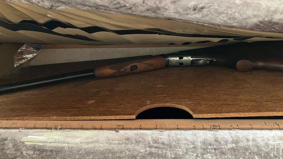 A shotgun hidden under a mattress