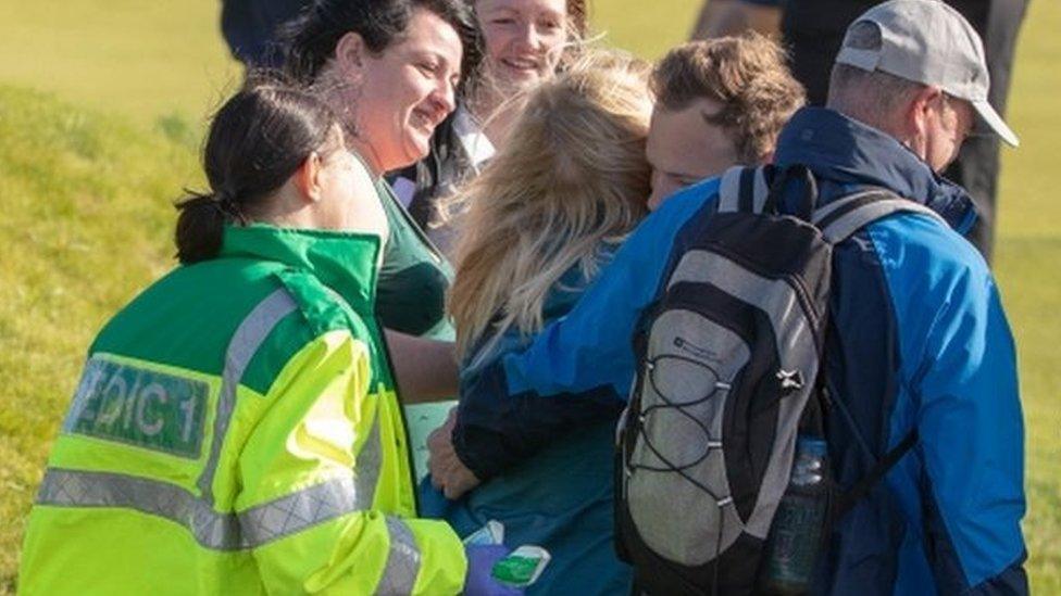 Paramedics and first aiders attending to spectator