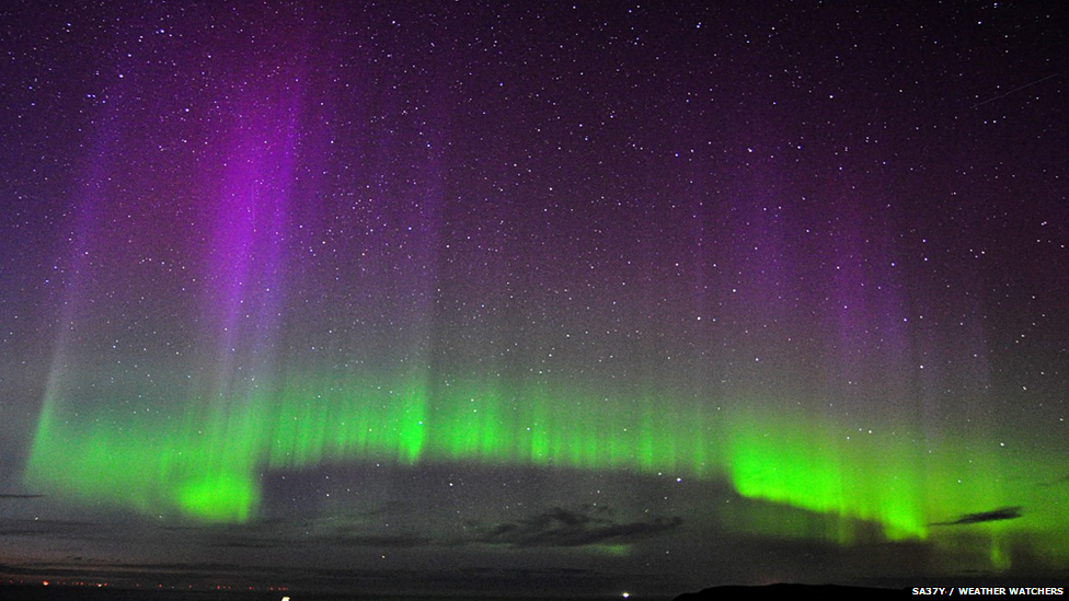 Aurora made up of bright green with purple streaks above