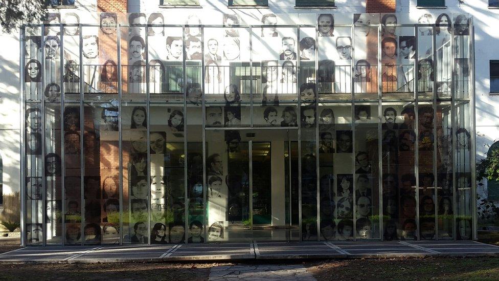 The entrance to the former naval school with pictures of people who were forcibly disappeared