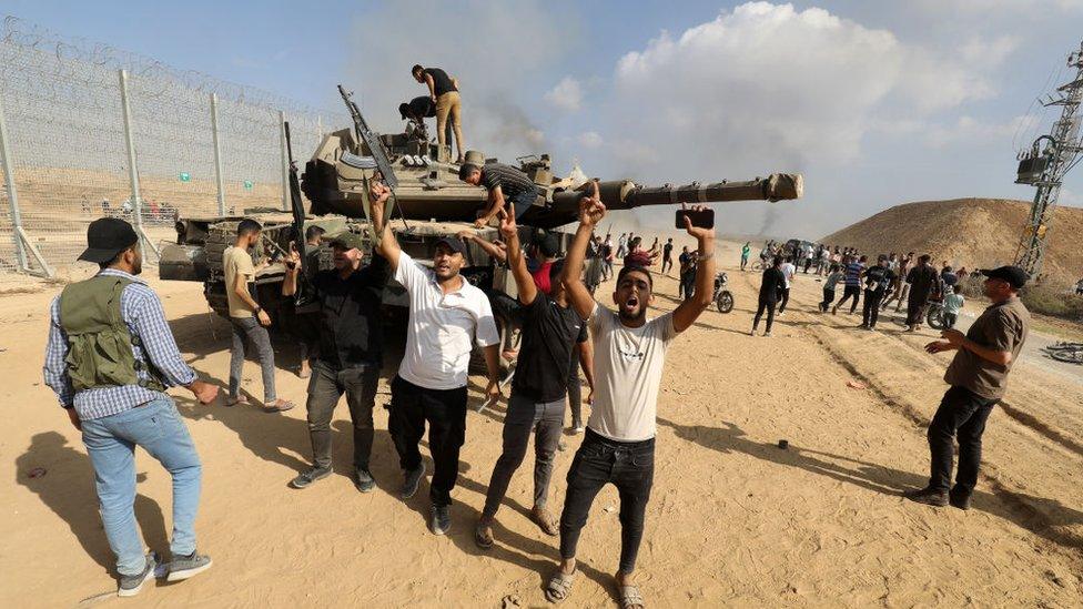 A picture showing Hamas militants with an Israeli tank