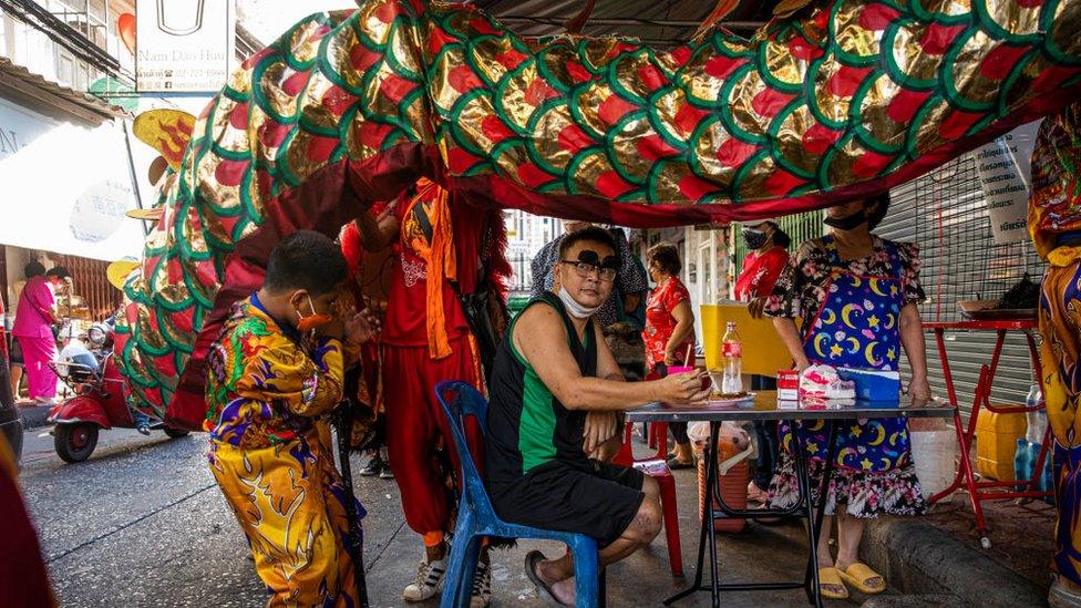 A dragon dance troop visits a restaurant in Chinatown in Bangkok, Thailand