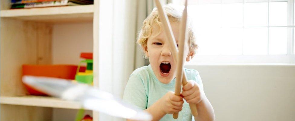 Boy with toy drums