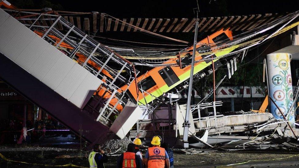 Rescue workers gather at the site of a train accident after an elevated metro line collapsed in Mexico City