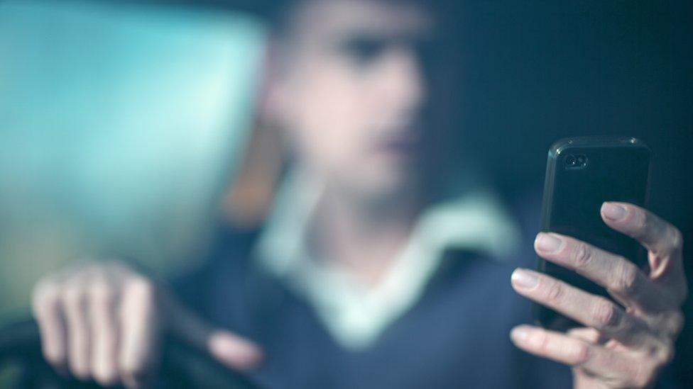 Man on phone while driving