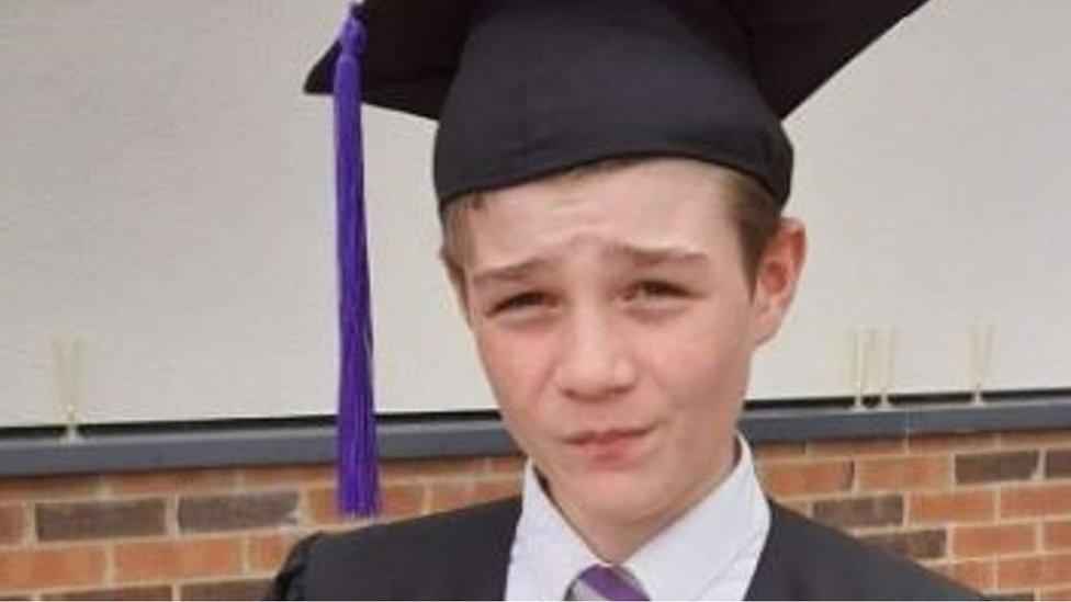 Robert Hattersley wears a graduation cap and gown at his school