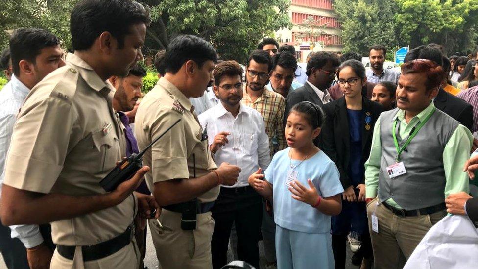 Licypriya Kangujam, eight, speaks with police who are trying to prevent her from demonstrating near India's parliament, 2019