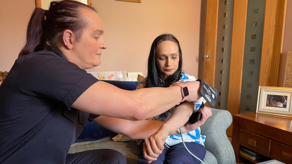 Kate Yates (left)from TWFRS carrying out a blood pressure test on Samantha Griffin (right)