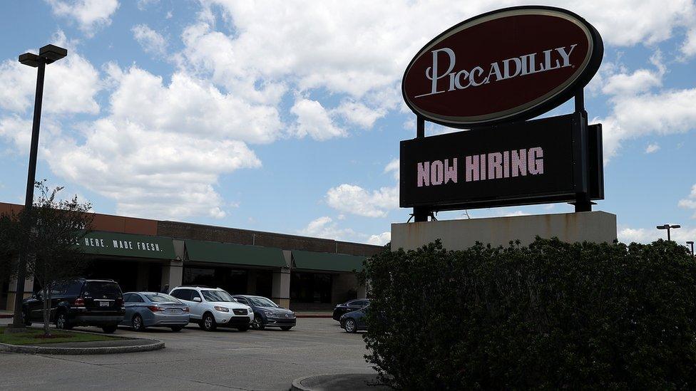 A now hiring sign is posted in front of a Picadilly restaurant on May 5, 2017 in Baton Rouge, Louisiana.