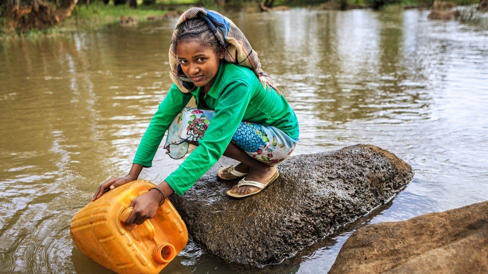 A child collecting water.