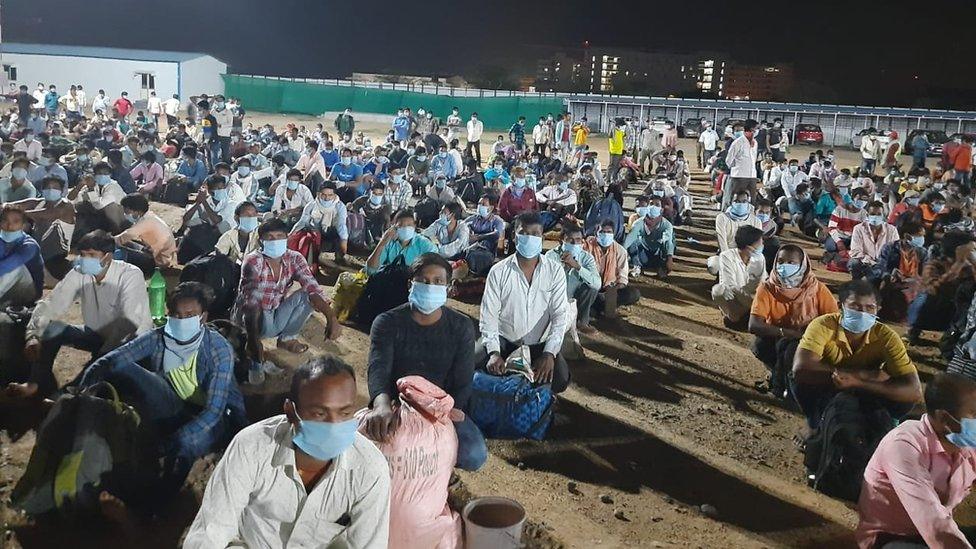 Migrant workers wait to board the first train carrying 1,200 passengers to eastern Jharkhand state.