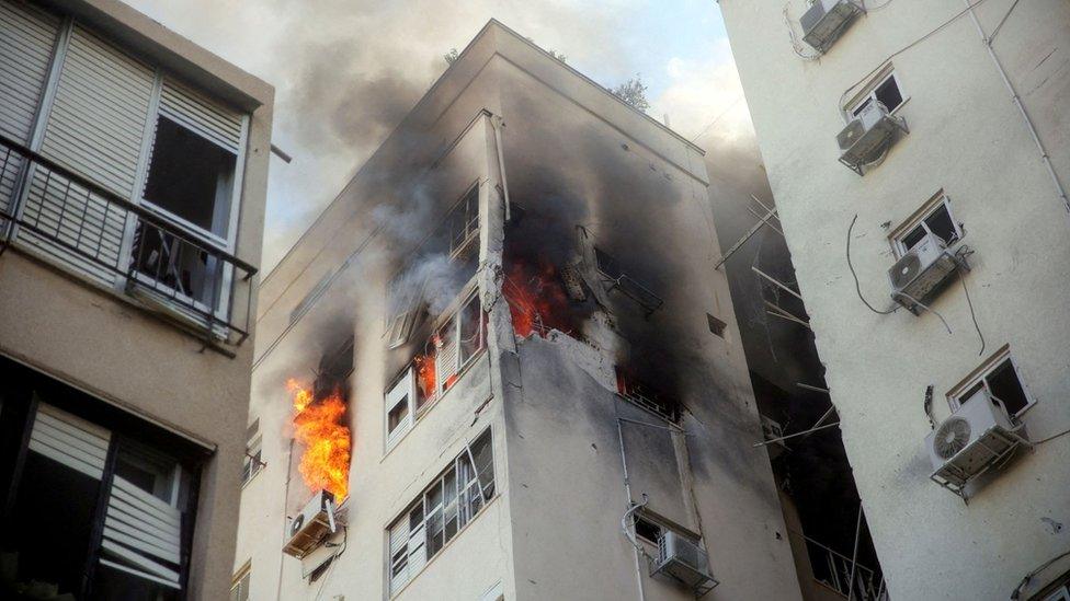 A building is ablaze following rocket attacks from the Gaza Strip, in Tel Aviv, Israel October 7, 2023