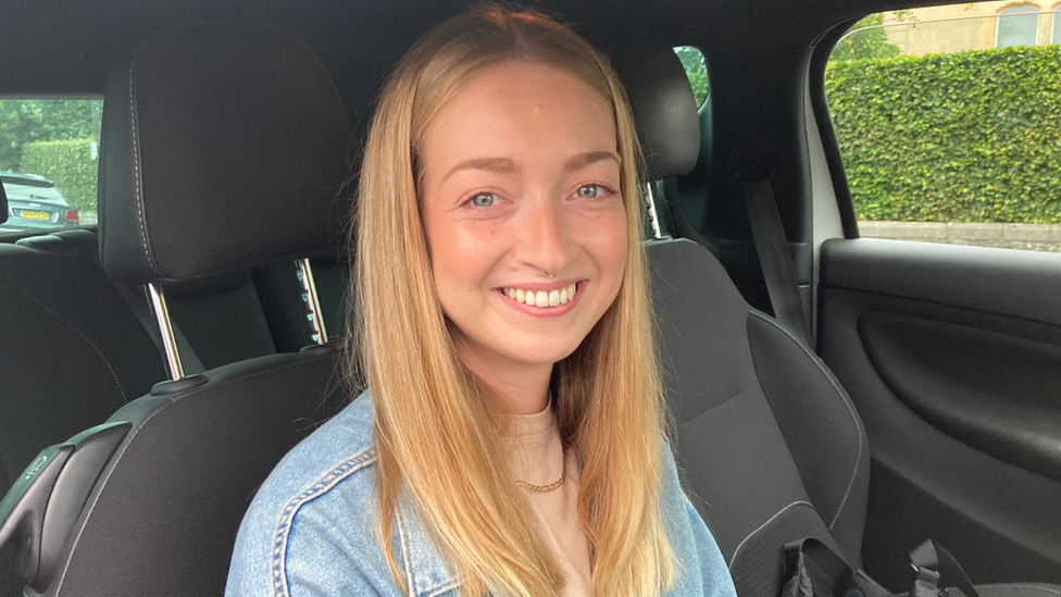 Newly qualified driver Poppy Allen sat in a car