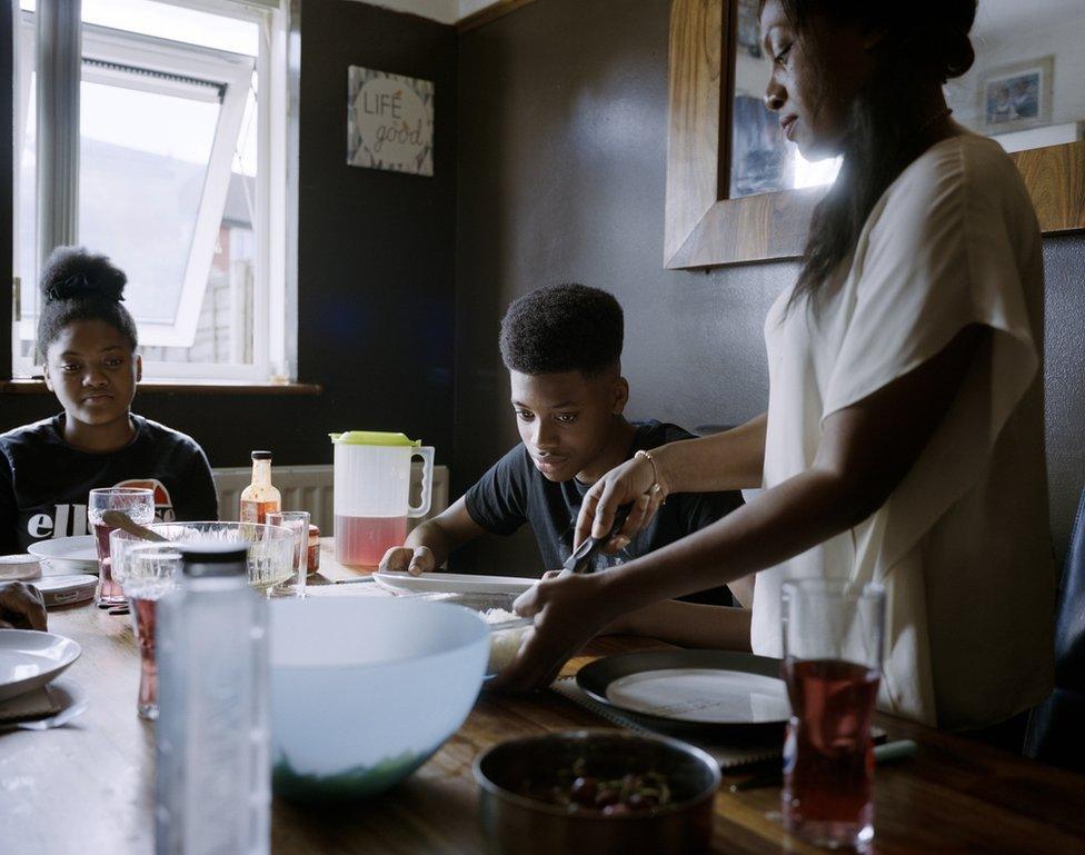 A woman serves rice.