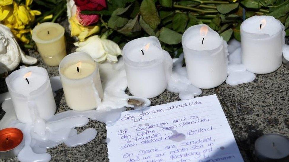 A letter, candles and flowers lie outside the Olympia shopping centre - the scene of Friday's shooting in Munich (24/07/2016)