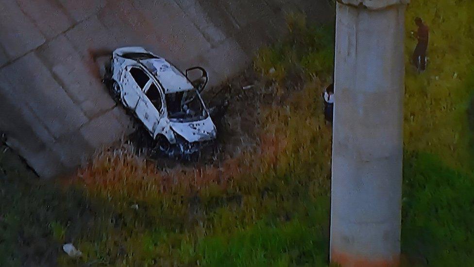 Picture of a TV set taken while TV Globo News shows the car of Greek ambassador in Brazil, Kyriakos Amiridis in Nova Iguacu on December 30, 2016