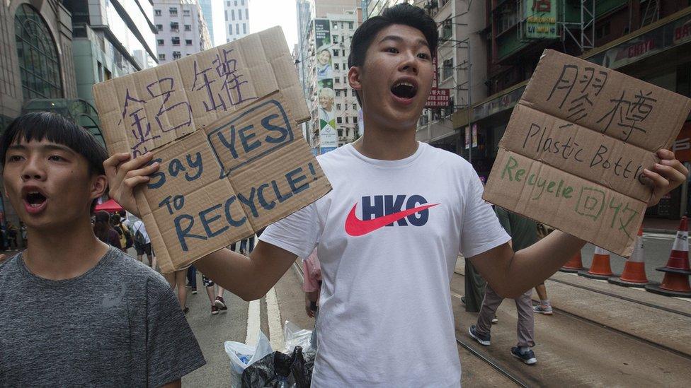 A protester encourages plastics recycling during the annual pro-democracy march, Wan Chai, Hong Kong, China, 01 July 2018.