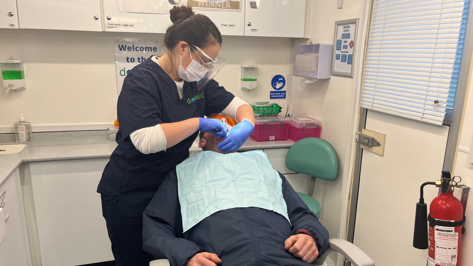 Dentist treating patient