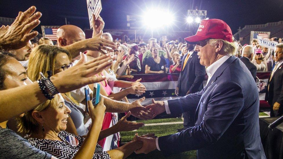 : Republican presidential candidate Donald Trump greets supporters after his rally at Ladd-Peebles Stadium on August 21, 2015 in Mobile, Alabama.