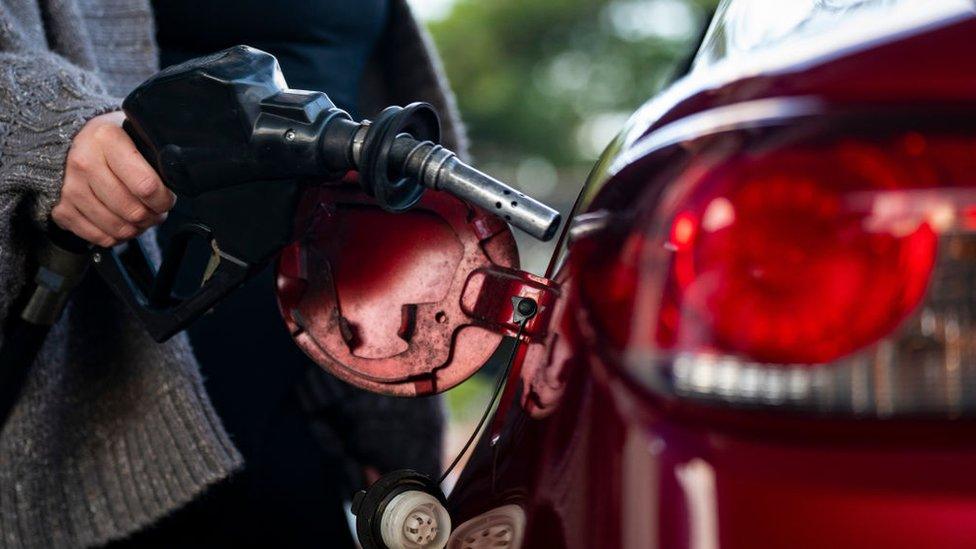 A driver pumps gas at a Sunoco gas station in Washington, DC, US, on Tuesday, Nov. 28, 203.