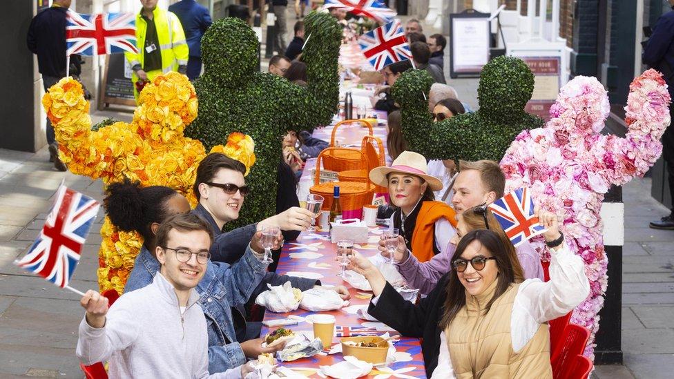 Guests sit at an 80 foot-long banquet table in Carter Lane in London, as part of Fleet Street Quarter's 'BIG Picnic'