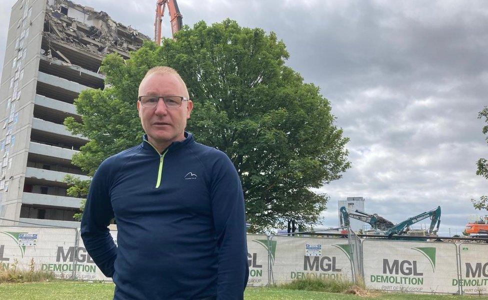 Councillor Ray Godwin in front of Anson and Hudson House which is being demolished