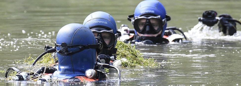 Divers of the French gendarmerie search for evidence in a pond near Pont-de-Beauvoisin, eastern france, on August 30, 2017