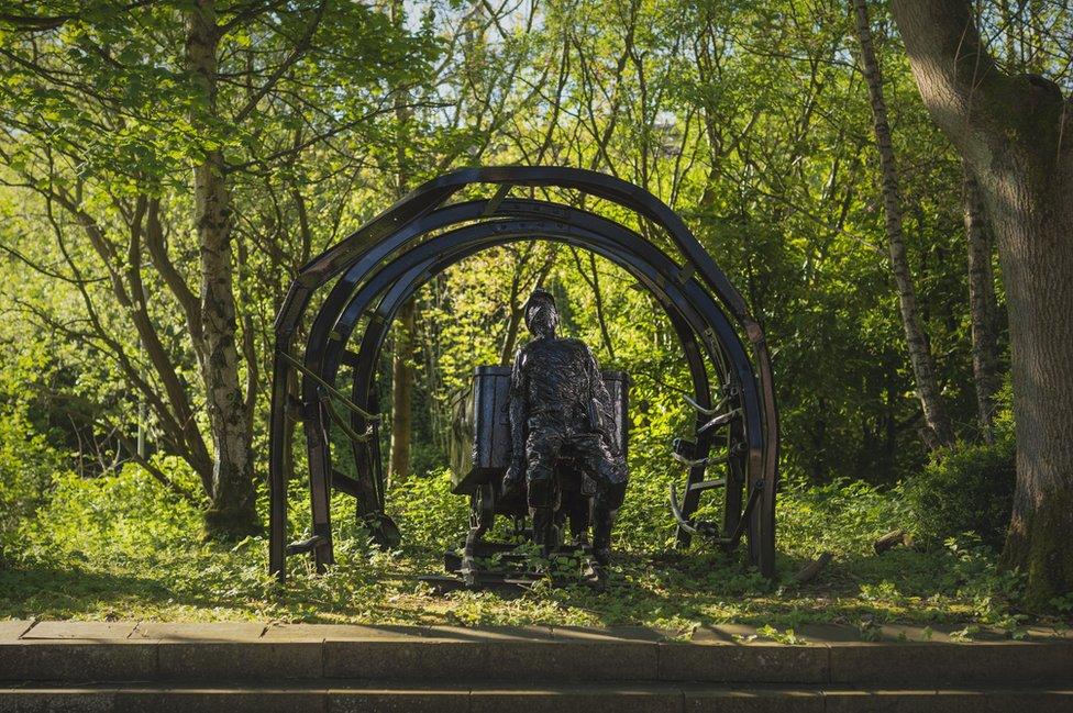 A sculpture of a miner in the Redhills grounds