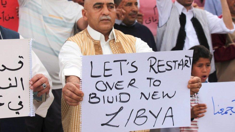 Supporters of Libya"s unity government hold signs during a demonstration at Martyrs" Square in Tripoli April 1, 2016. REUTERS/Hani Amara