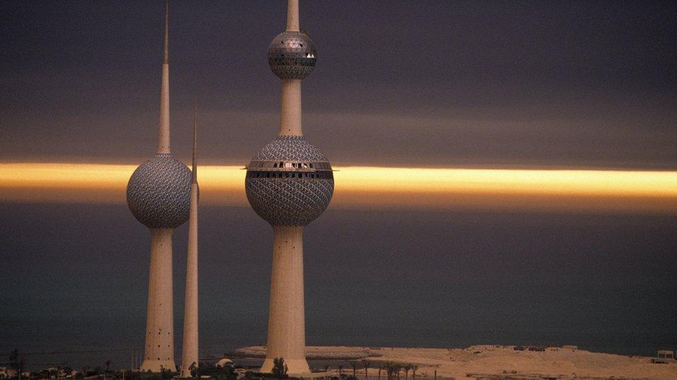 Oil well fires in the Kuwaiti desert that were burning out of control during the 1991 Gulf War helped create the strange mood of this photograph of the Kuwaiti Towers.