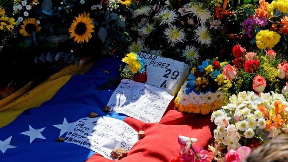 Former elite police officer Oscar Perez"s grave identified with a brick surrounded with flowers at a cemetery in Caracas on January 21, 2018