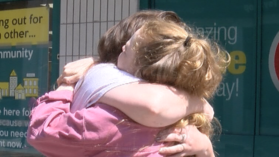 Two friends hugging
