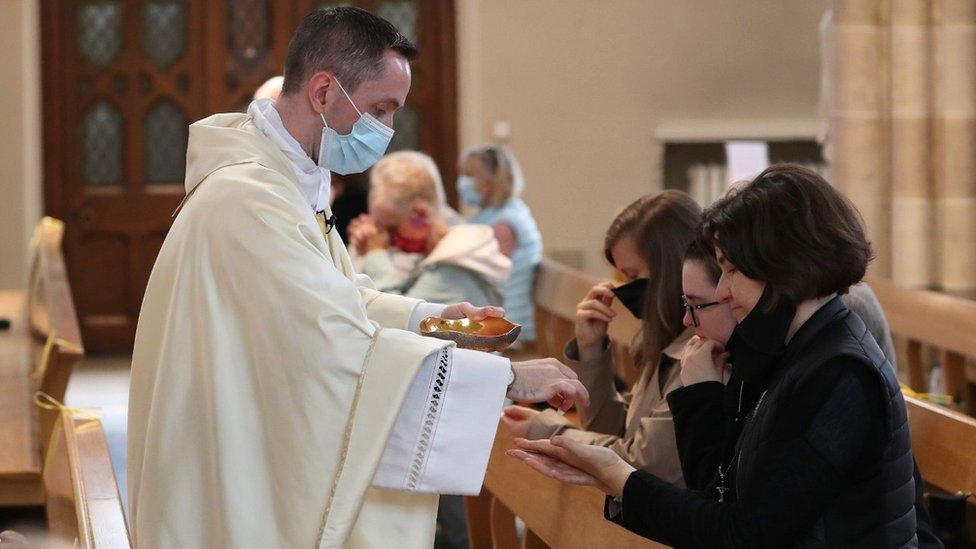 Canon Gerald Sharkey during Communion at the first mass held at St Andrew's Cathedral in Glasgow since 19 March