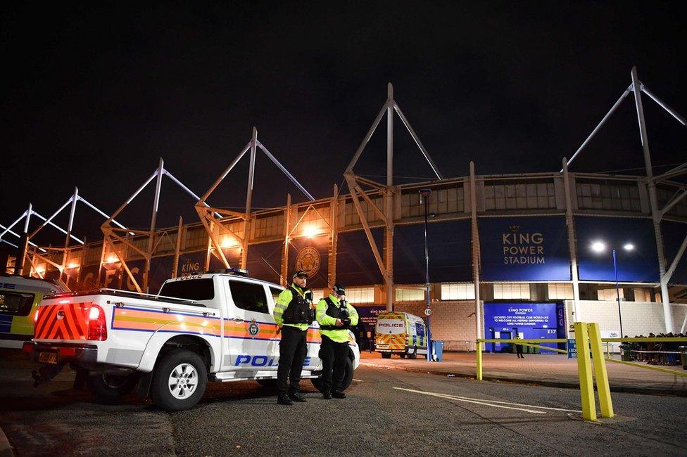 Police officers secure the area outside Leicester City Football Club's King Power Stadium in Leicester, eastern England, on October 27, 2018 after a helicopter crashed in a car park outside the stadium