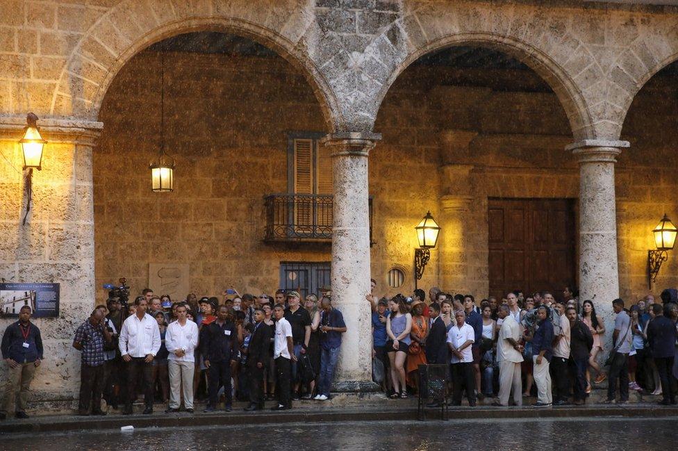 Tourists and local residents wait for the arrival of President Barack Obama for a tour at Old Havana with his family at the start of a three-day visit to Cuba, in Havana