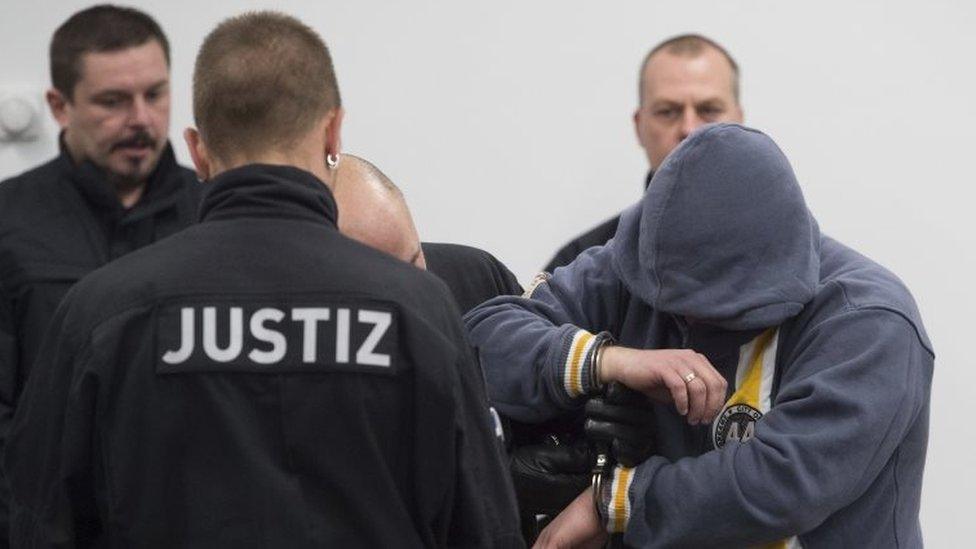 One of the suspects (right) enters the hearing room at the start of the trial in Dresden, Germany. Photo: 7 March 2017