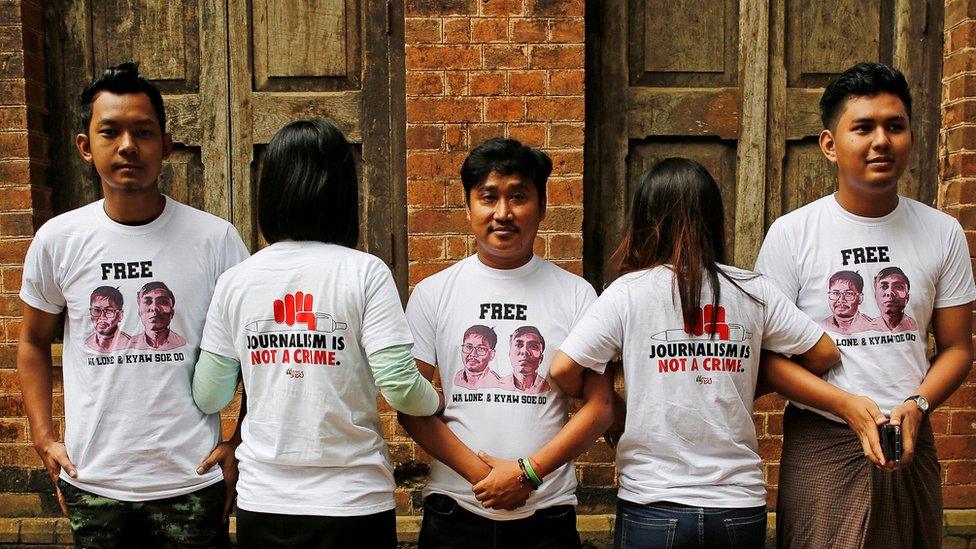 Friends of detained Reuters journalists Wa Lone and Kyaw Soe Oo stand at Insein court