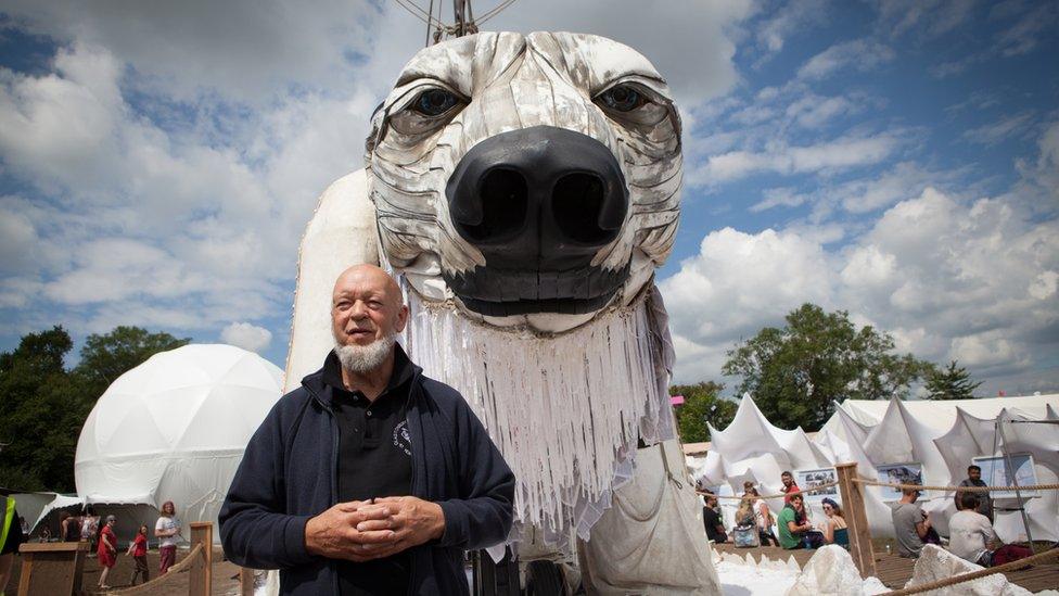 Michael Eavis in the Greenpeace Field, in front of the giant polar bear Aurora.