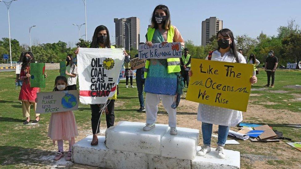 Climate activists hold placards as they take part in a demonstration in support of the environmental and climate protection movement 'Fridays for Future' in Islamabad on March 19, 2021