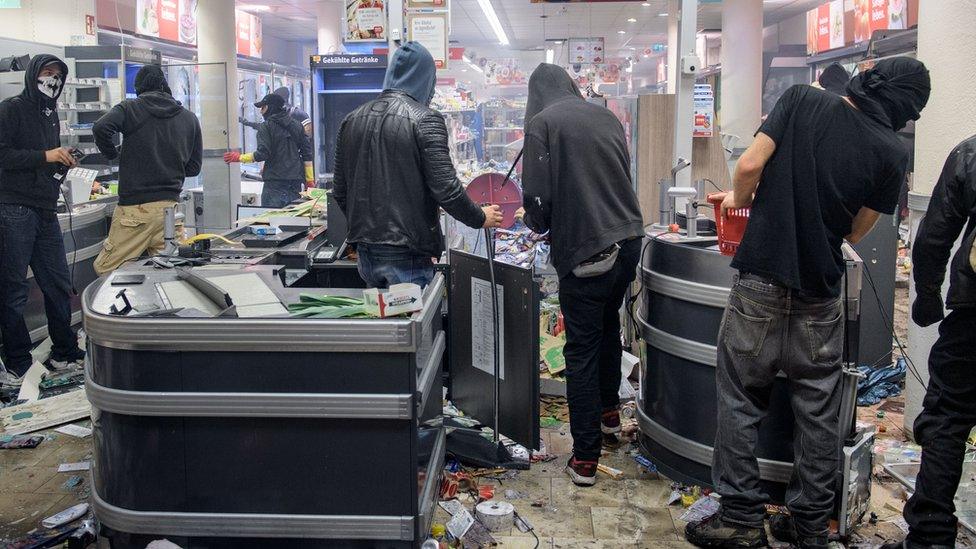 Black Bloc militants looting supermarket