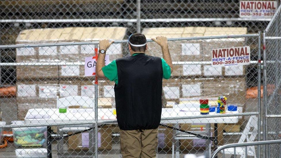 A Cyber Ninjas contractor looks at the ballots