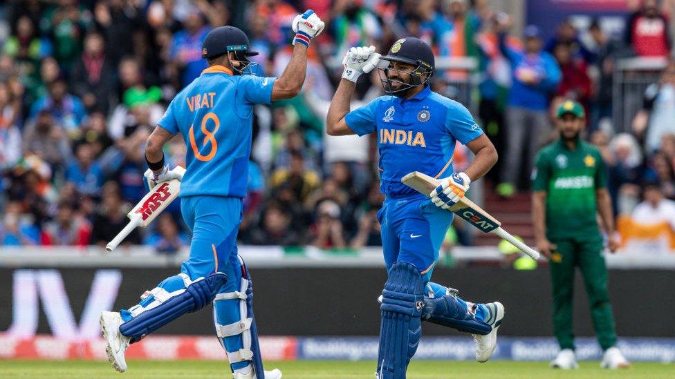 Virat Kohli of India (L) punches the air as team mate Rohit Sharma reaches his century during the Group Stage match of the ICC Cricket World Cup 2019