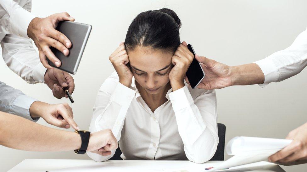 Woman being bombarded with devices