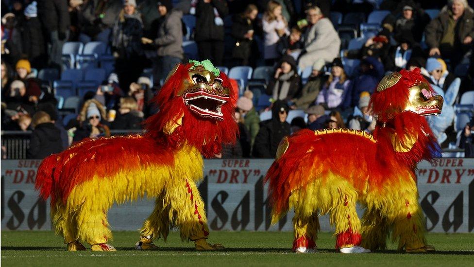 Mascots are seen during half time in celebration of the Chinese New Year at Manchester City v Aston Villa