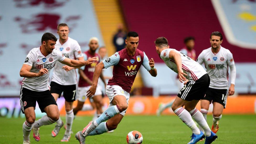 Anwar El Ghazi of Aston Villa is challenged by Jack Robinson of Sheffield United