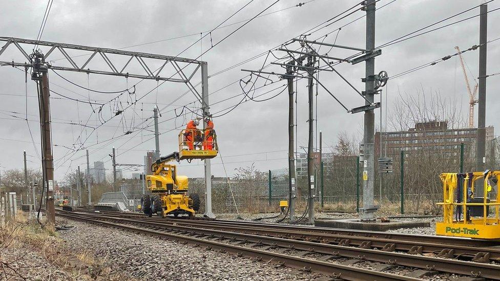 Engineers repairing damaged overhead line