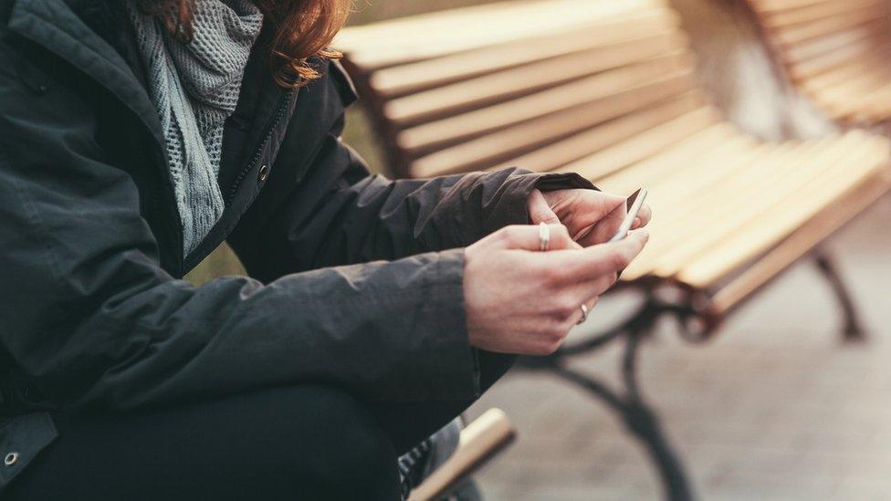 Teenager using phone (generic)