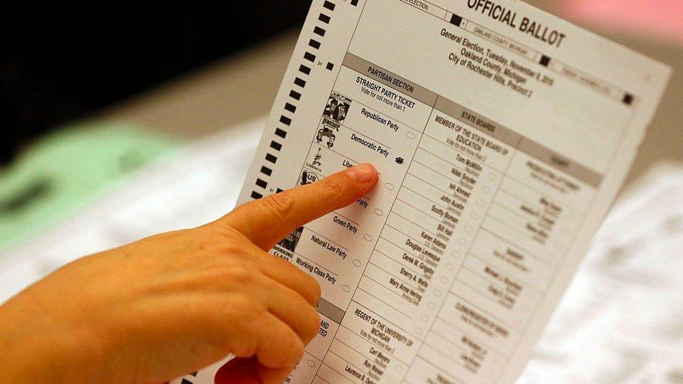 An election worker points at a ballot in the 2016 US presidential election