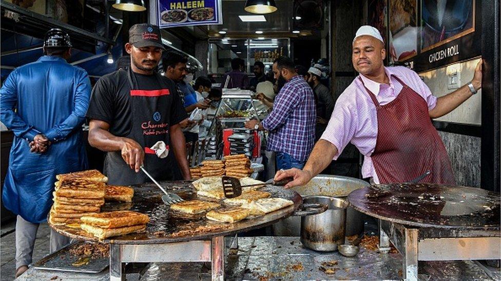 A restaurant cook prepares a dish named kheema roti at a restaurant for the Muslim devotees prior to the breaking of their fast on the first day of the holy fasting month of Ramadan, in Bangalore on April 3, 2022