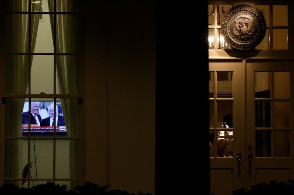 A television at the White House shows Trump's meeting with the Russian ambassador